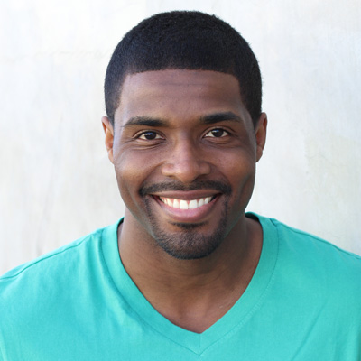 An elderly couple poses for a photo with smiles on their faces.