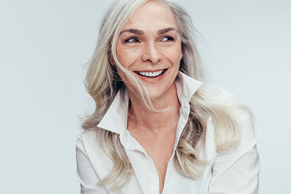 A woman with short hair smiling at the camera.